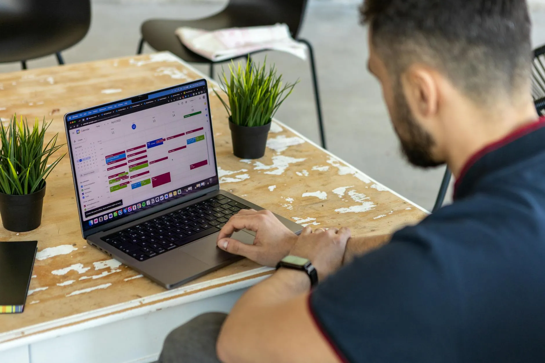Service professional reviewing a weekly calendar on a laptop during a short morning planning session