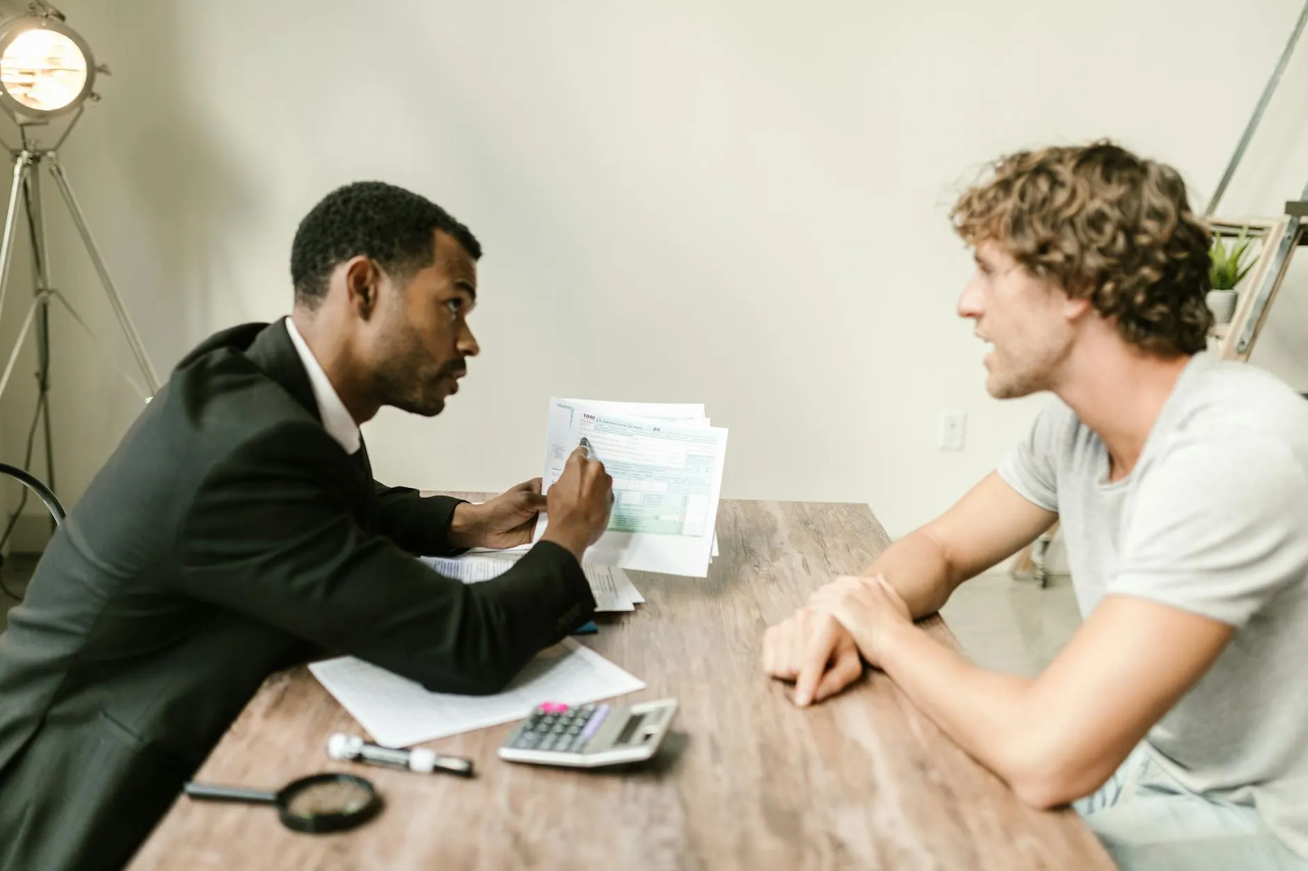 Financial advisor reviewing social media content on a laptop in a modern office