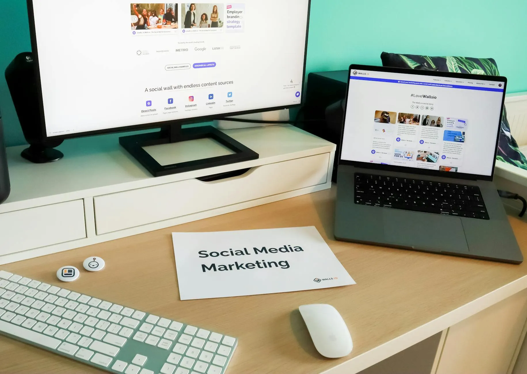 Workspace with laptop and monitor showing social media marketing dashboards, representing a comparison of scheduling tools